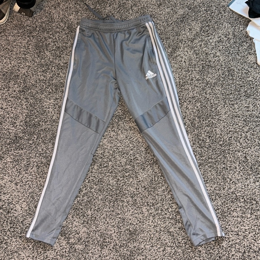 Grey adidas athletic joggers with zippers. Size small.